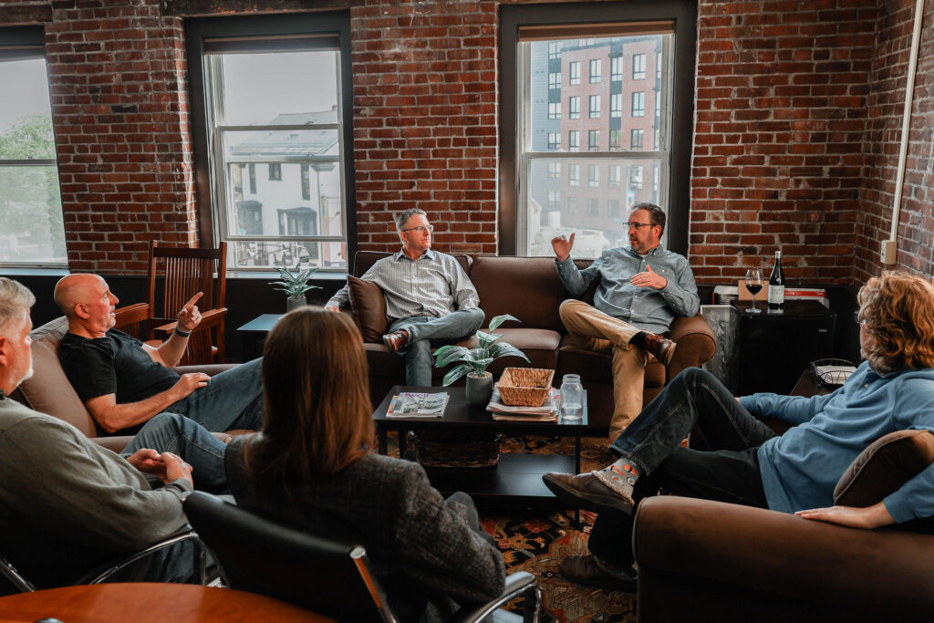 The reveler team sitting in a laid back discussion room.