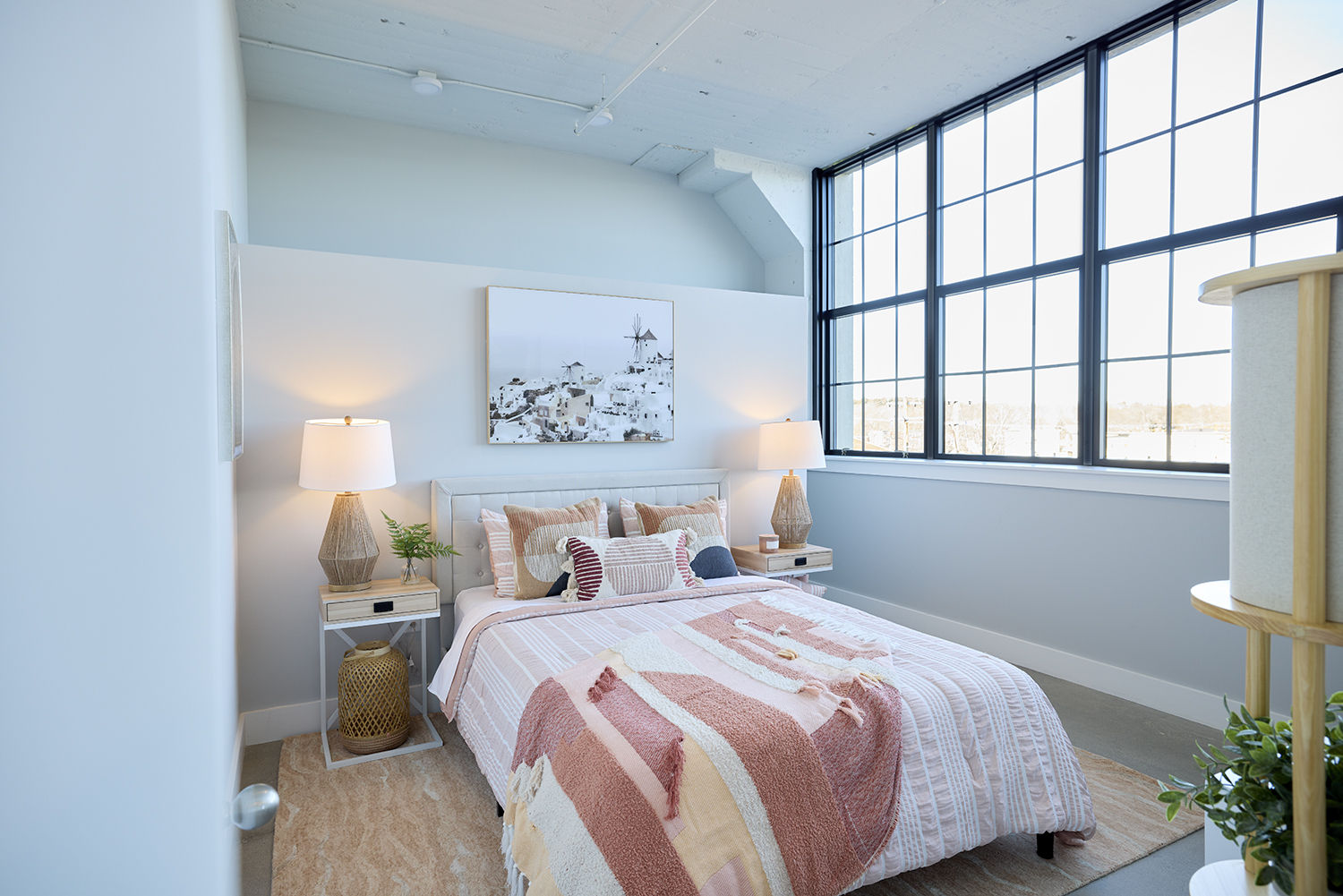 A bright bedroom with high ceilings.